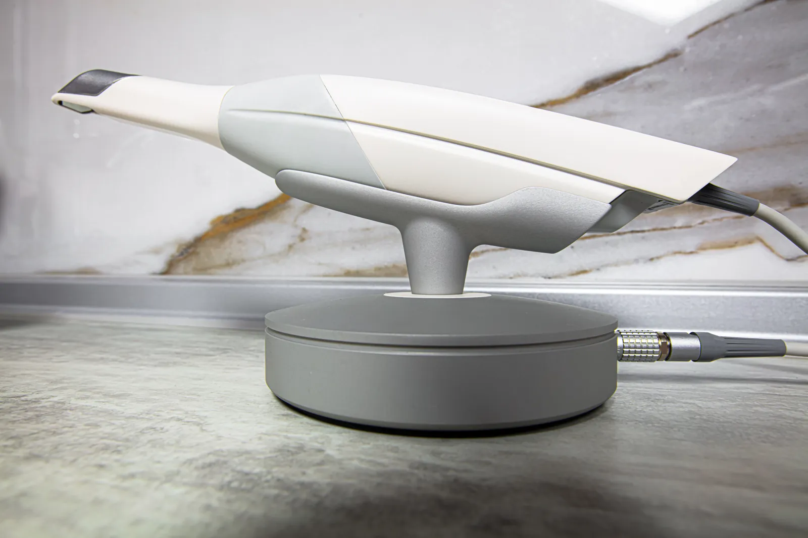 An intraoral scanner on a clinic counter