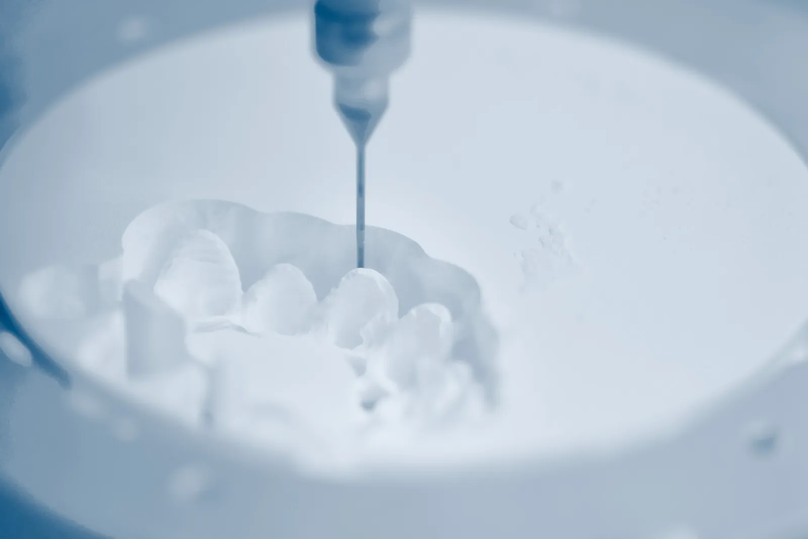 A dental milling machine carving a restoration